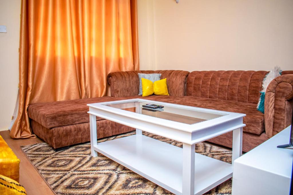 a living room with a couch and a white coffee table at EDD'S HOME AWAY FROM HOME in Kisii