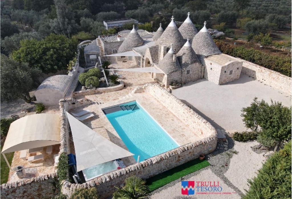 an aerial view of a house with a swimming pool at TRULLI TESORO in Cisternino