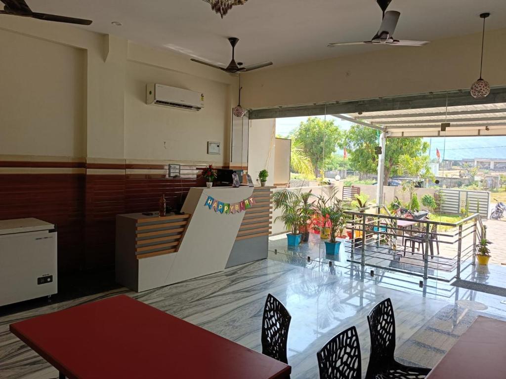 a kitchen and dining room with a table and chairs at Hotel Raj 2 KM from Janana Hospital and 1 KM from MDS University in Ajmer