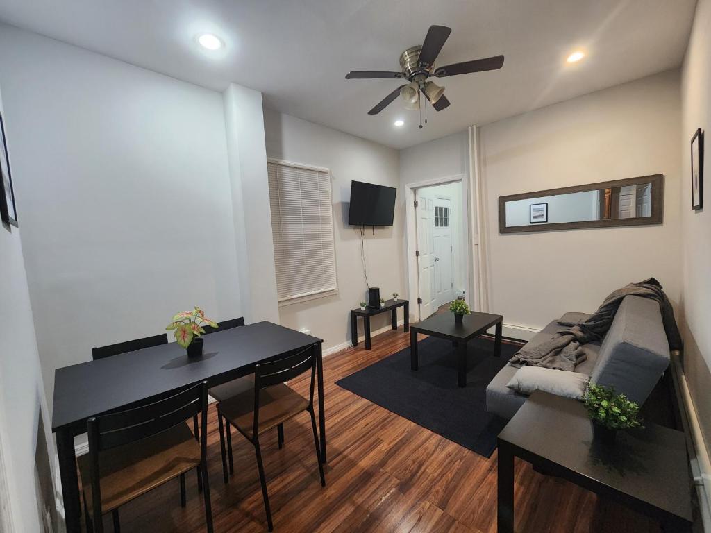 a living room with a table and a couch at Prime Location 3-Bed Close to NYC in Jersey City