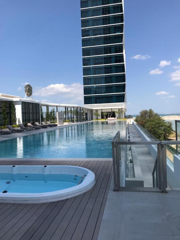a swimming pool with a jacuzzi on a building at Penang Amazing SeaView Private Lift 梹城富人区绝美海景公寓私人电梯 in Tanjong Tokong