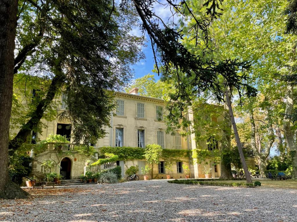 una casa grande con árboles delante de ella en La Suite de la Bastide, en Val-de-Dagne