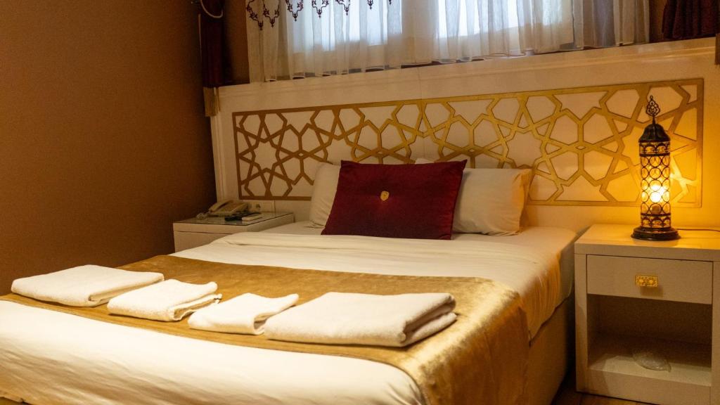a bedroom with a bed with towels on it at İpek Palas Otel in Urfa
