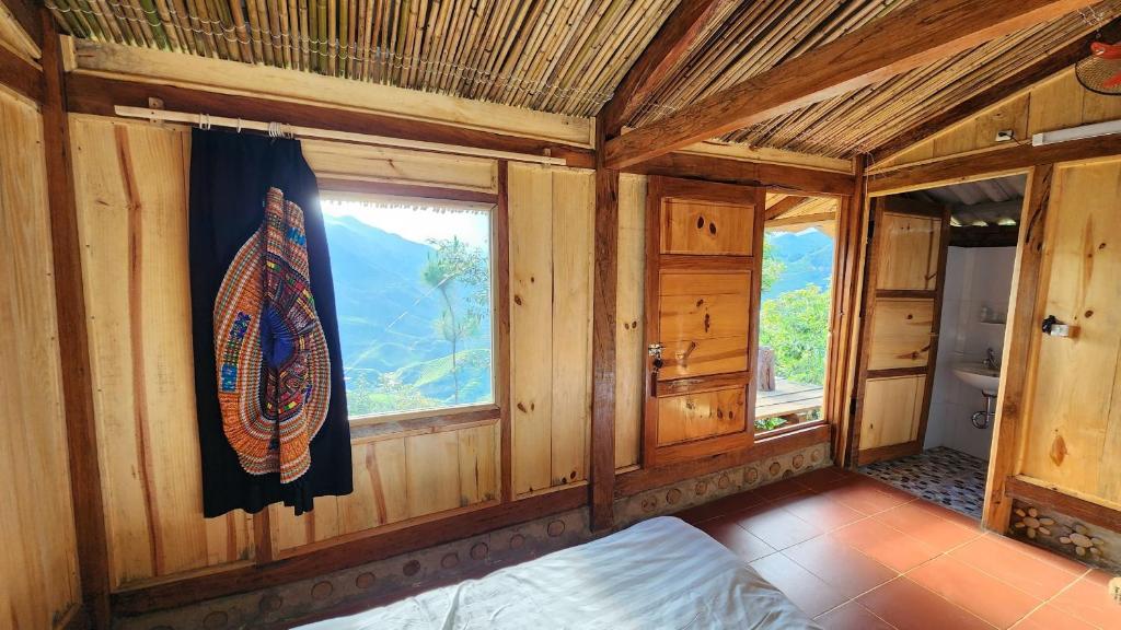 See bungalow في Mù Cang Chải: غرفة خشبية مع نافذة وطاولة تزلج على الحائط