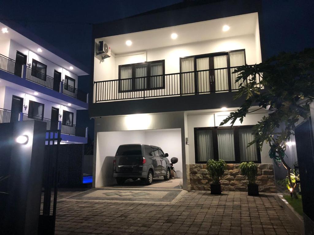 a car parked in front of a building at night at Danja House and Kost in Jimbaran