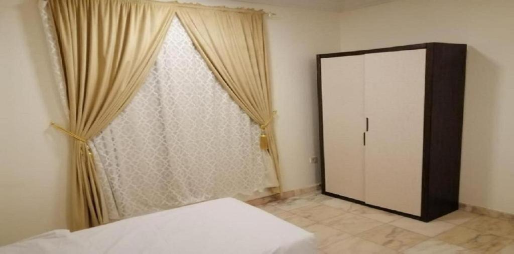 Postel nebo postele na pokoji v ubytování حياة ريف للوحدات السكنية المفروشة