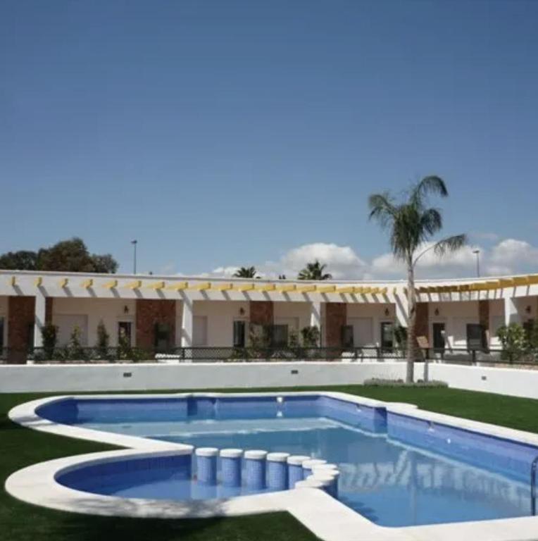 a large swimming pool in front of a building at Cielo Azul in Campoamor