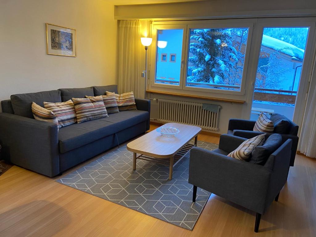 a living room with two couches and a table at Near ski slopes 2 bedrooms apartment with balcony in Saas-Fee