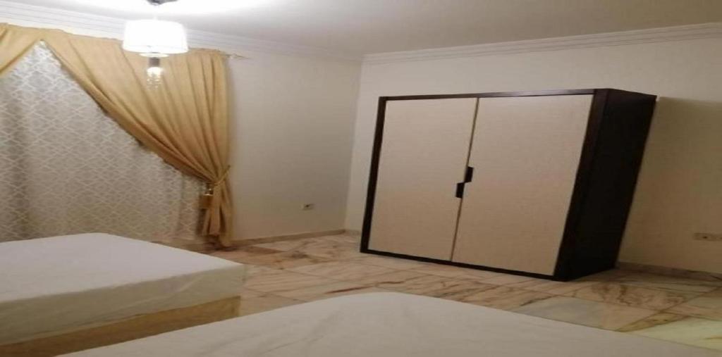 Postel nebo postele na pokoji v ubytování حياة ريف للوحدات السكنية المفروشة