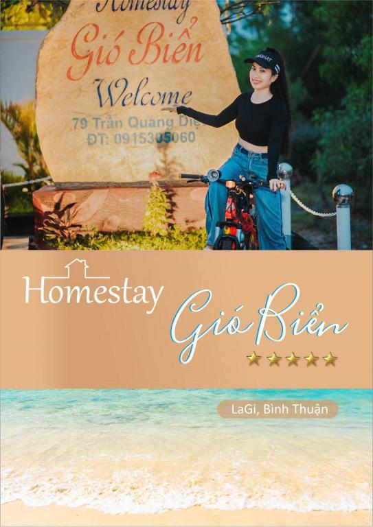 a woman riding a bike in front of a sign at VILLA GIÓ BIỂN LAGI - Villa Gia đình 4 Phòng Ngủ, Sức chứa 8 - 20 Khách, Cách Biển Cam Bình 700m di chuyển, Sân Vườn Rộng Rãi, Tiện Nghi Nướng BBQ & Bãi Đậu Xe Ô tô Miễn Phí in Lagi