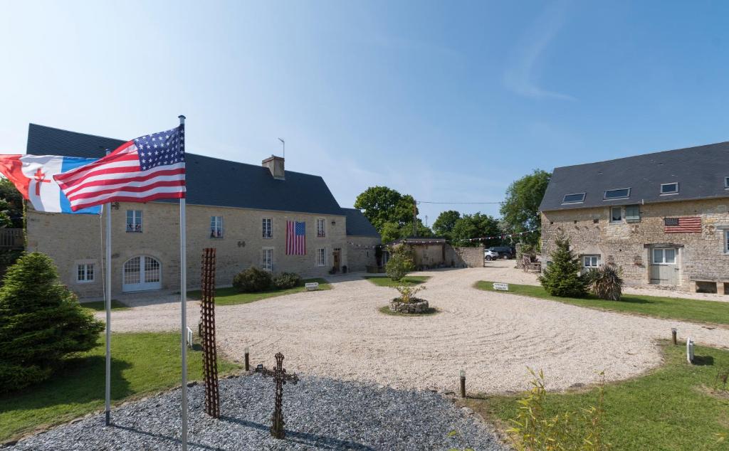 a house with an american flag in front of it at Spirit of 1944 in La Cambe