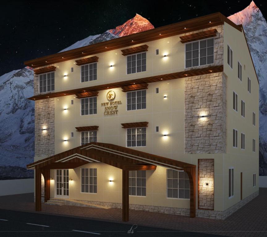 a model of a building with a mountain in the background at New Hotel Snow Crest in Badrīnāth