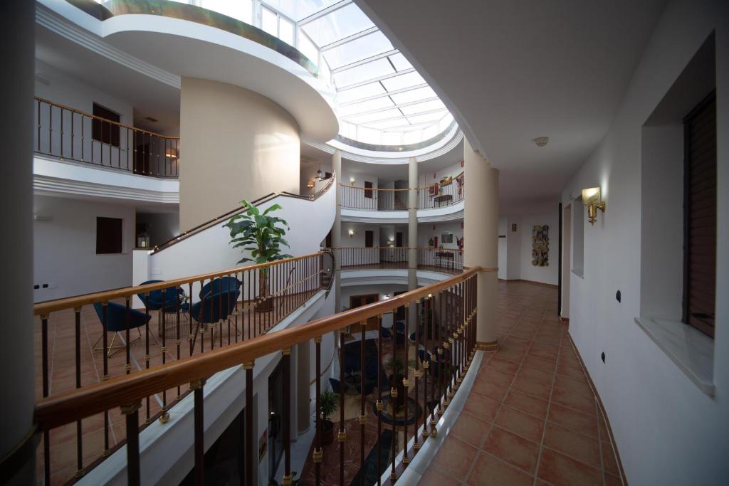 a large building with a skylight and a hallway at HOTEL HACIENDA SANTA BARBARA in Castilleja de la Cuesta