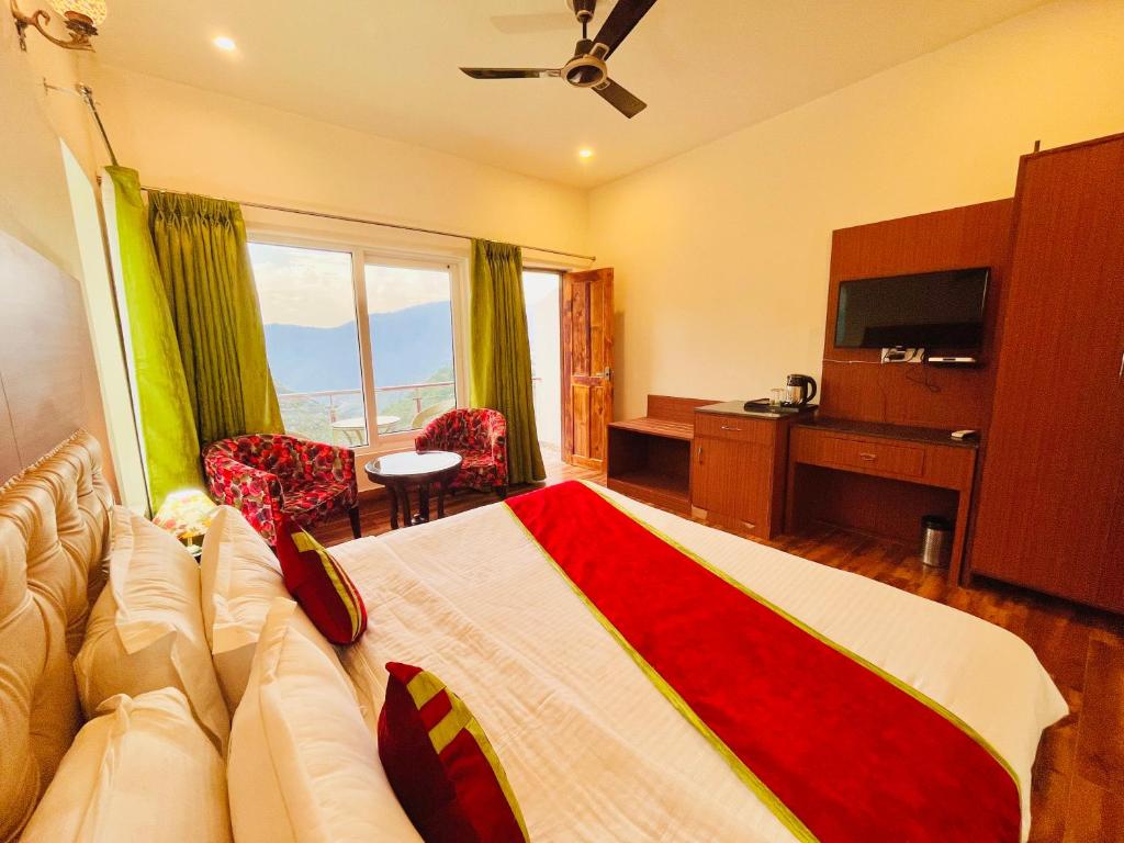 a hotel room with a couch and a television at The Nature Valley View Resort, Mussoorie in Mussoorie