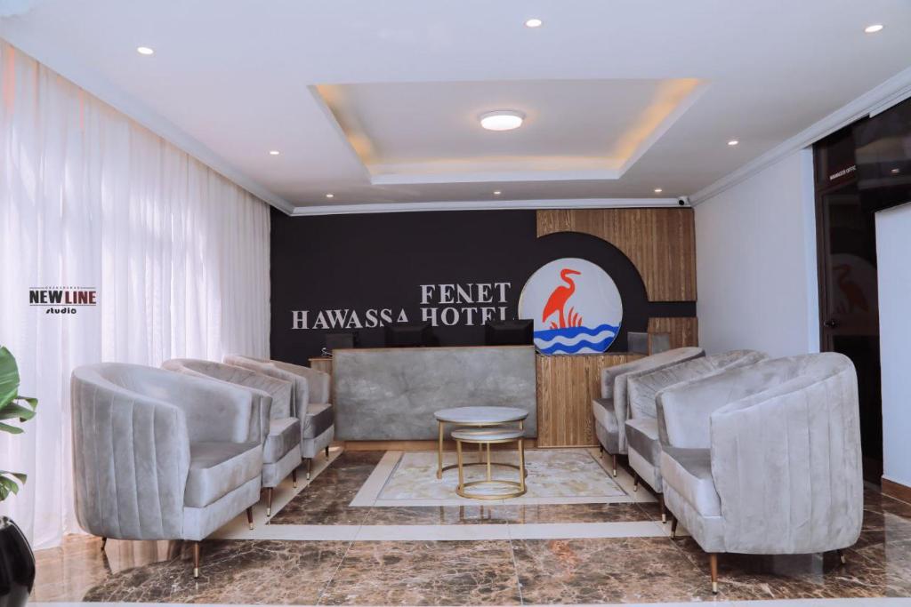 a waiting room with chairs and a table at Fenet Hawassa Hotel in Āwasa