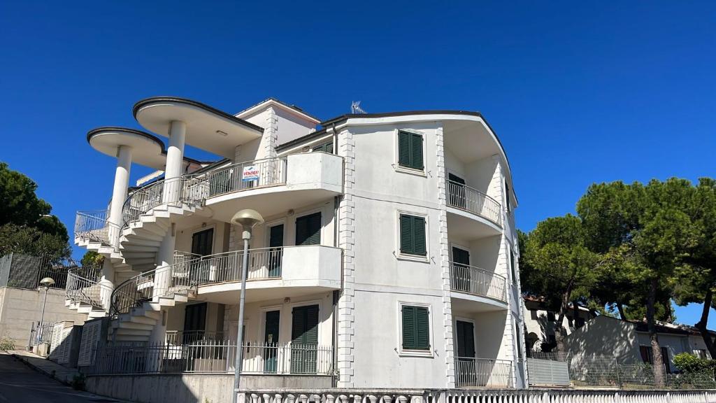 a white building with balconies on the side of it at Casa Vacanze da Mary in Porto Recanati