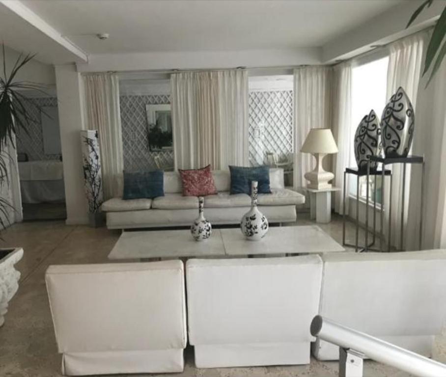 a living room with a couch and a table at Hotel Americana in Punta del Este