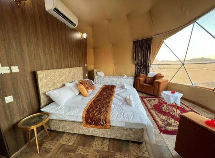 a bedroom with a large bed in a tent at Desert Life Camp in Wadi Rum