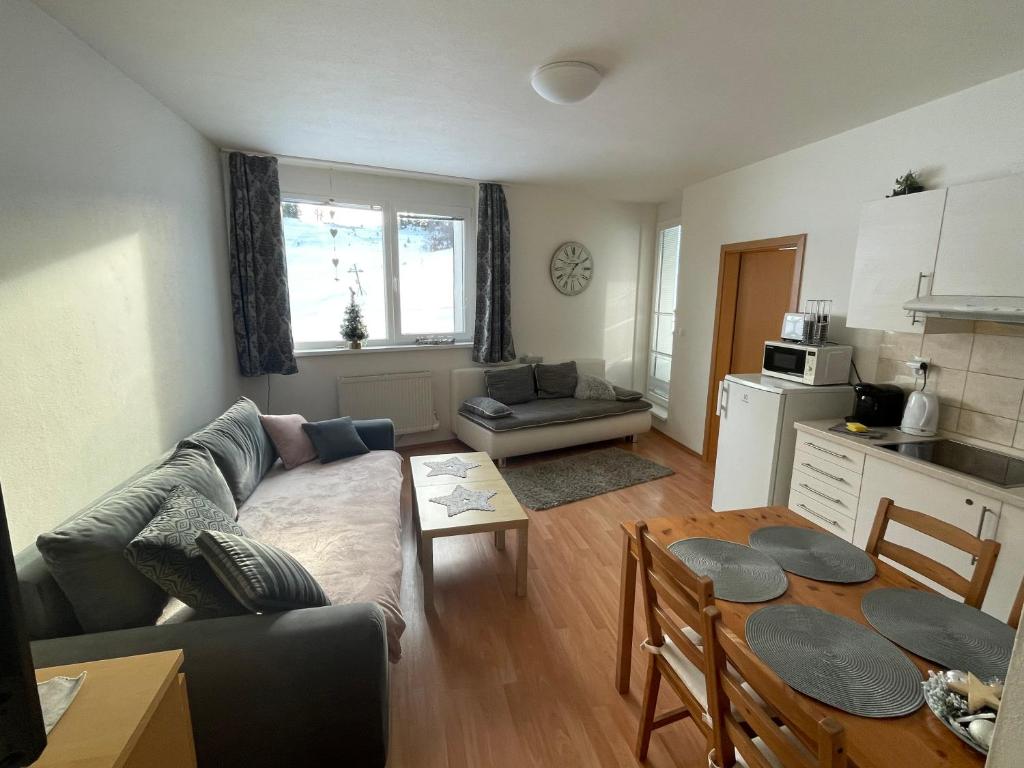 a living room with a couch and a table at Apartmán 6 Triangel in Donovaly