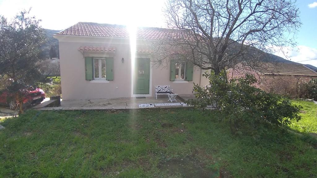 a small white house with the sun shining on it at Casa Sulla Montagna in Loutses