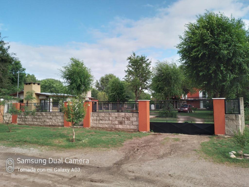 a retaining wall in front of a house at Nancy's Residencias in Santa Rosa de Calamuchita