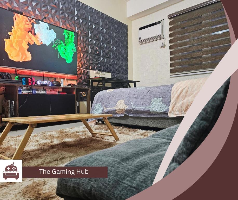 a living room with a tv and a table at Gamingcation in Manila
