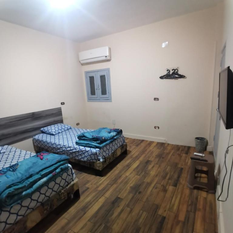 Postel nebo postele na pokoji v ubytování Economy Pyramids Inn