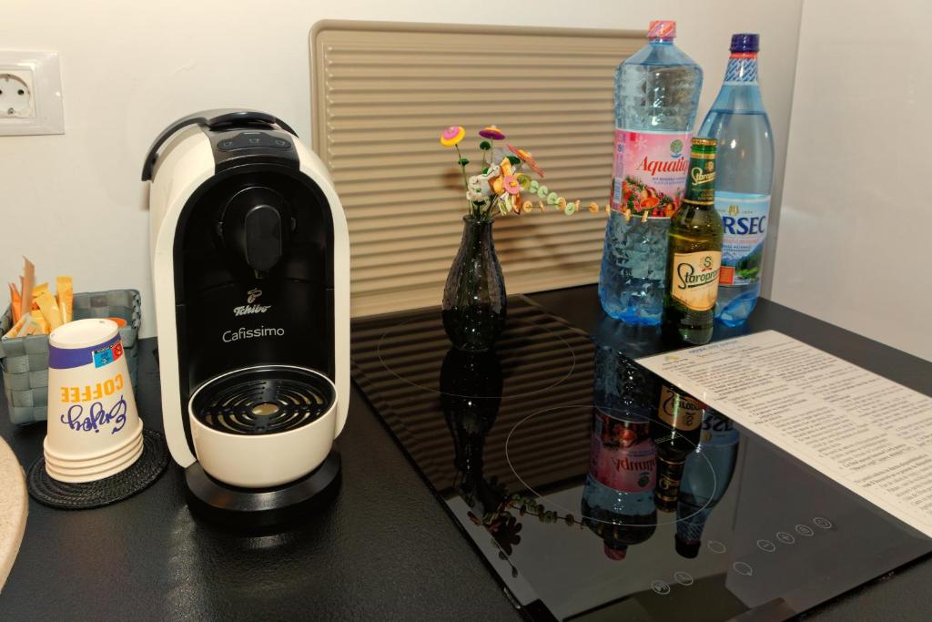 a black counter with bottles of water and a blender at AMADA CITY CENTER in Iaşi