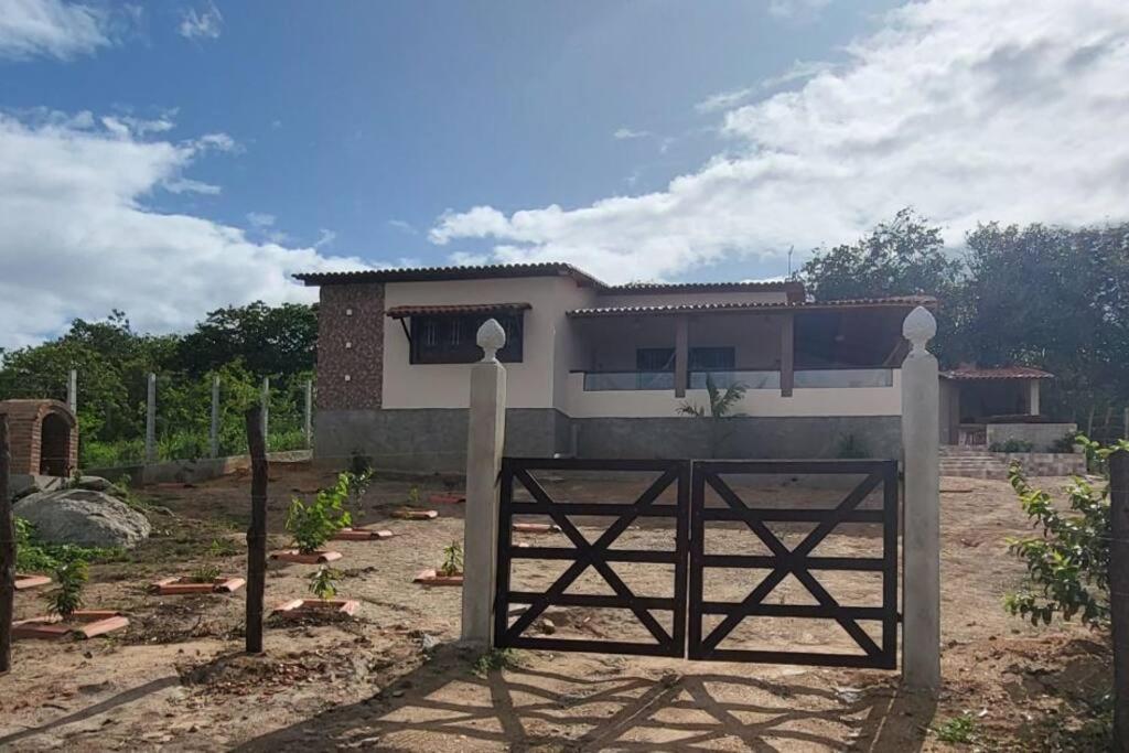 a house with a gate in front of it at Solar Serra Negra Bezerros - PE in Bezerros