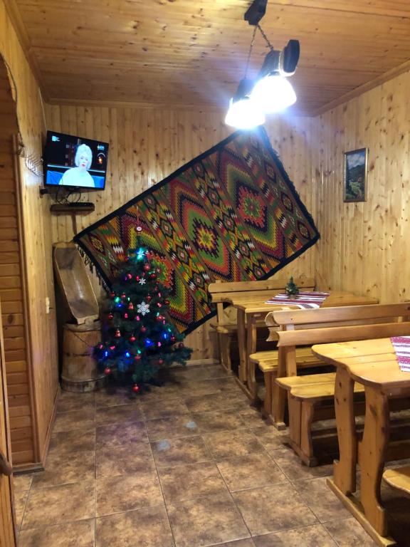 a christmas tree in the corner of a restaurant at U Pana Ivana in Yaremche