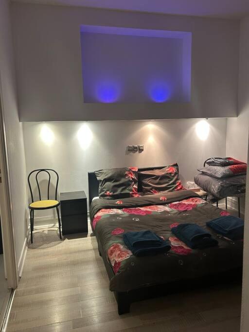 a bedroom with a bed and a tv on the wall at Superbe appartement avec parking gratuit in Vaulx-en-Velin