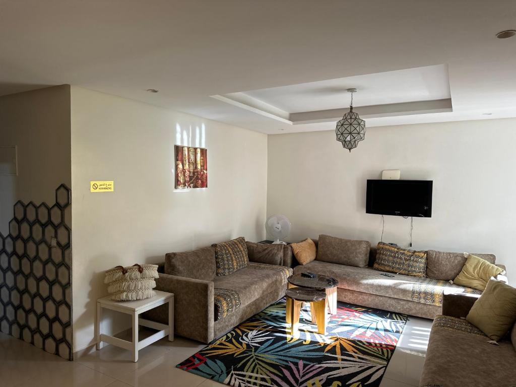 a living room with a couch and a flat screen tv at Lovely city center flat near the old Medina in Casablanca
