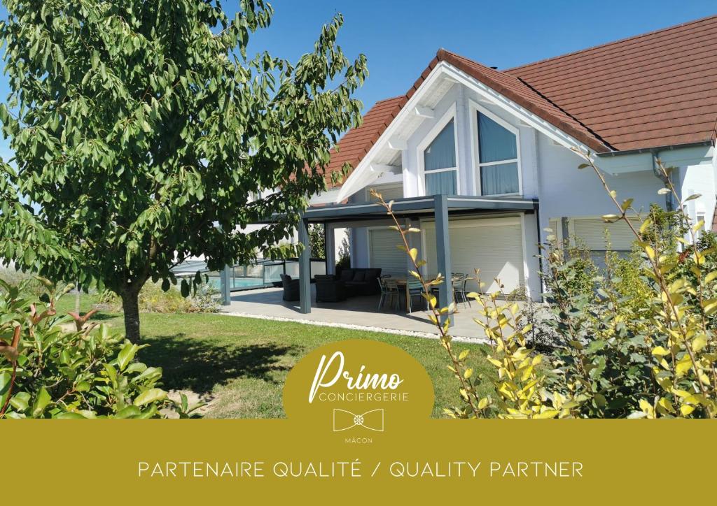 a house with a sign that reads dining furniture venture outsidequality partner at Gite de Mortagne, Chalet avec Piscine - BY PRIMO C0NCIERGERIE in Gigny-sur-Saône