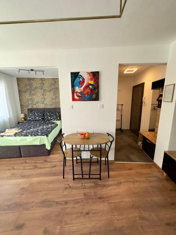 a room with a table and a bed at Студио за нощувки Габрово in Gabrovo