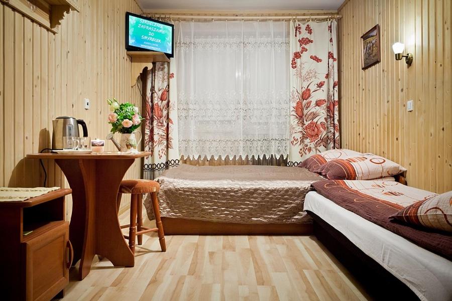 Postel nebo postele na pokoji v ubytování Smyrecek-centrum Bukowiny