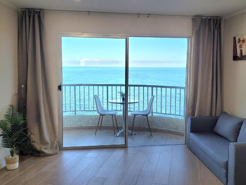 a living room with a view of the ocean at Cosy ocean view studio 2 in San Marcos