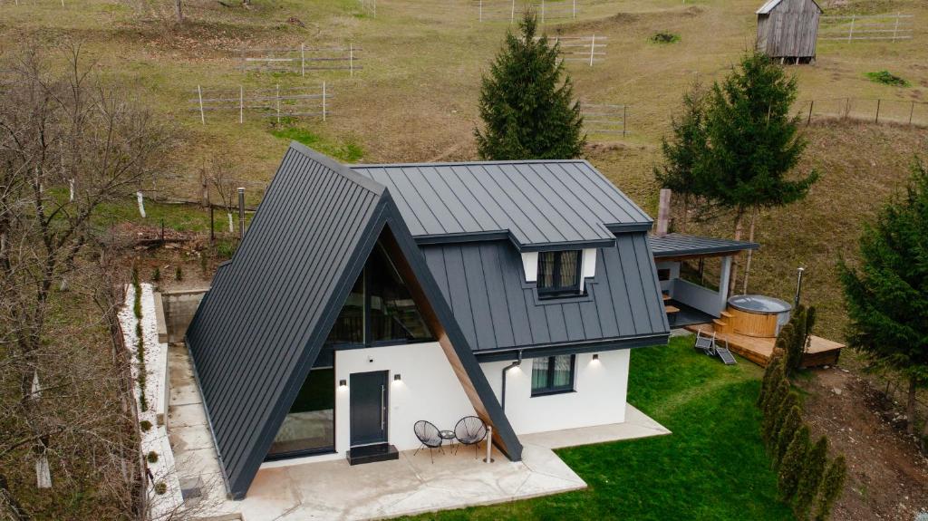 an overhead view of a house with a grey roof at Cabana A-Frame NorthLand in Borşa