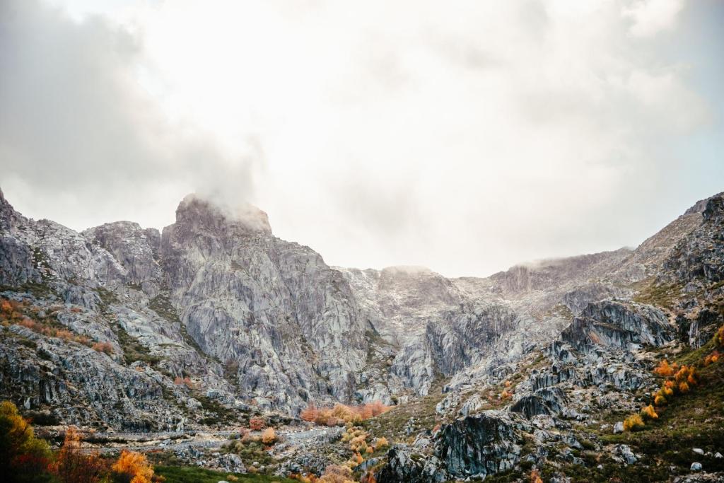 a view of a mountain range with fall foliage at Casa do Boco in Oliveira do Hospital
