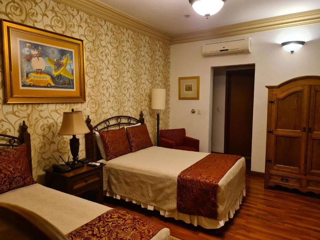 Кровать или кровати в номере Hotel Casa Divina Oaxaca