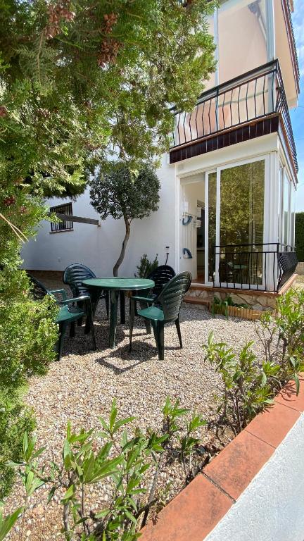 a patio with a table and chairs in front of a house at Gran sol de la Farella in Llança