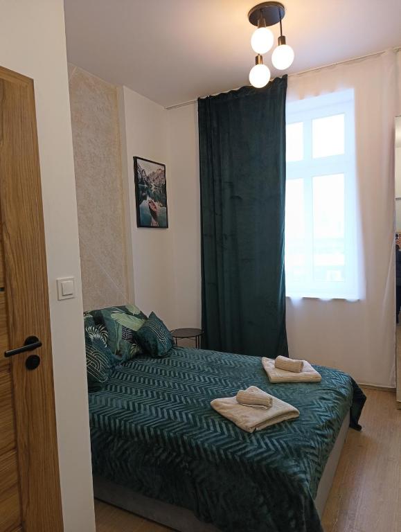 Łóżko lub łóżka w pokoju w obiekcie MH Apartments Centrum