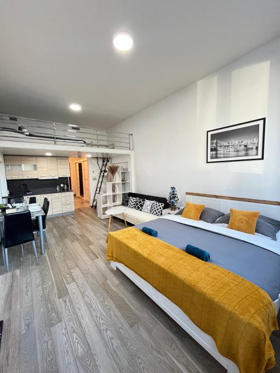 a large bedroom with two beds and a kitchen at VIT Apartment - Free Parking - O2 Arena in Prague