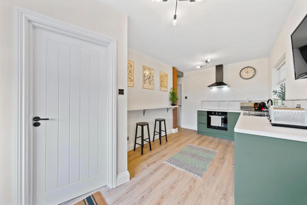 a kitchen with a door leading into a kitchen with a counter at The Buccleuch Luxury Apartments in Kettering