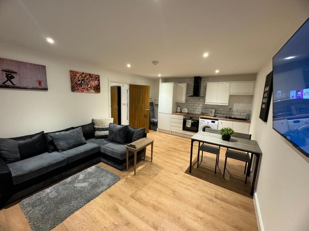 a living room with a couch and a table at LT Apartment 52 - Free Street Parking in Leicester