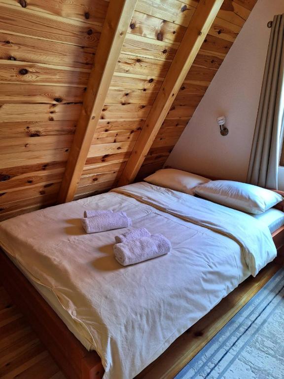 a bed with two towels on it in a room at House Bojana in Žabljak