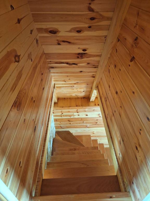 an inside view of a wooden sauna with wooden stairs at House Bojana in Žabljak