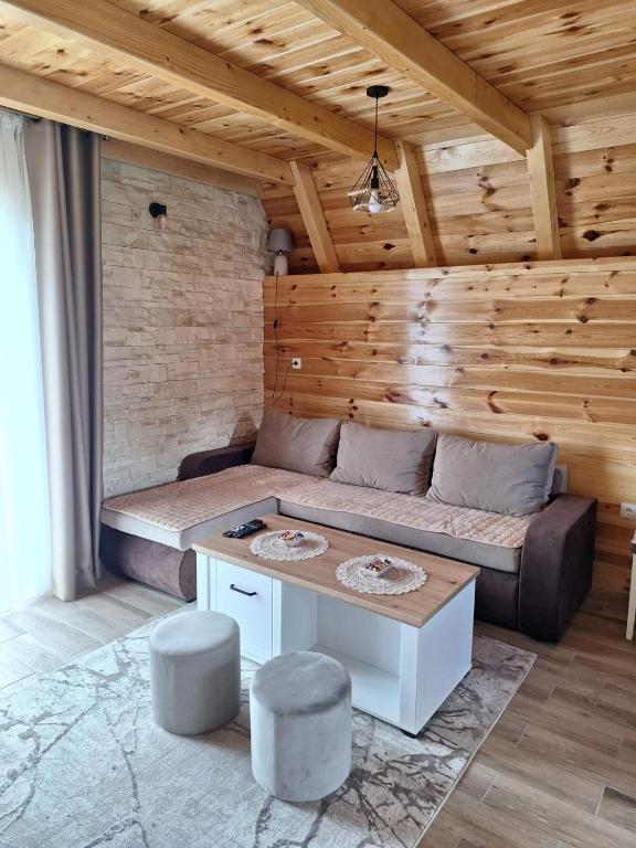 a living room with a couch and a table at House Bojana in Žabljak