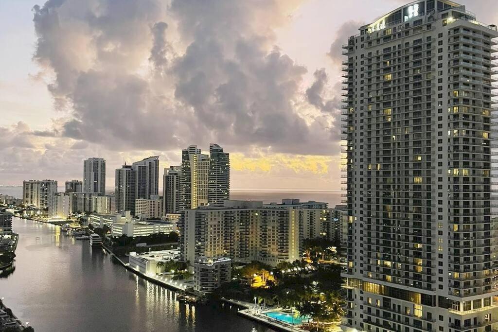 a tall building next to a river with a city at Lovely 1 Bedroom & 1 Bath Kitchen Balcony 18 Floor in Hallandale Beach