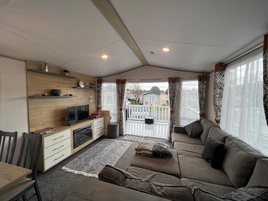 a living room with a couch and a television at The Willows in Selsey