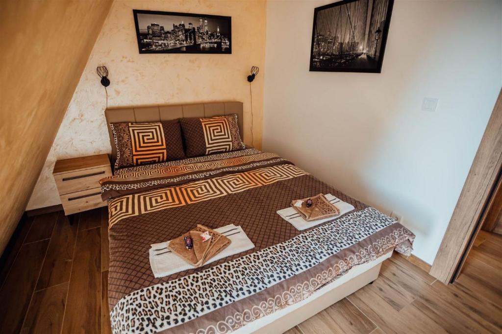 ein Schlafzimmer mit einem Bett mit zwei Handtüchern darauf in der Unterkunft Apartman Petar 26 in Divčibare
